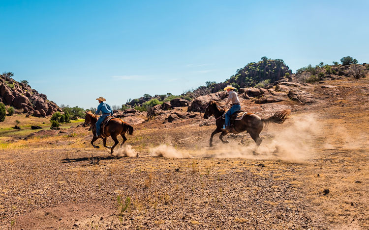 Two men riding horses 